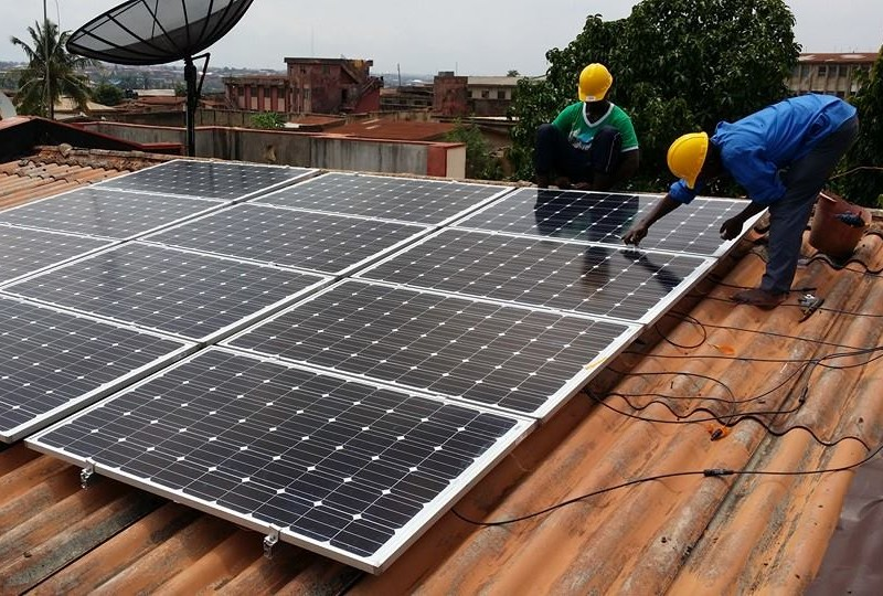 PowerLink solar technicians installing a rooftop solar panel array in Lagos